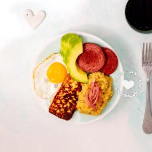 a plate of breakfast food with eggs and fruit at The Short STOP free Breakfast private Apartment in Monte Plata