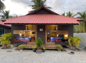 a small house with two beds in it at Homestay Umbai Kelana in Merlimau