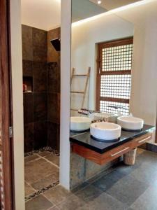 a bathroom with two sinks and a shower at Villa Presito in Ronda