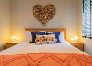 a bedroom with a bed with a heart on the wall at Hill Crest - cliff top cottage with stunning views in Cullen