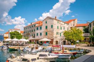 a group of boats are docked in a harbor at Apartments Lucija in Postira