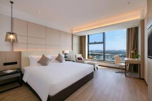 Postel nebo postele na pokoji v ubytování Kew Green Hotel Hongqiao Shanghai + 29 fotografií