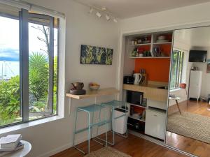 a small kitchen with a counter and a window at Waterfront Bliss in Nelson