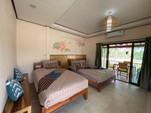 Ένα ή περισσότερα κρεβάτια σε δωμάτιο στο เชียงคานพาราไดร์รีสอร์ท&มีตติ้ง