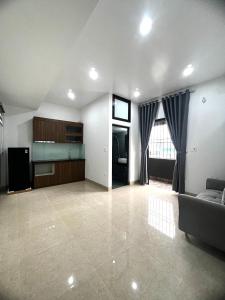 a large living room with a couch and a kitchen at Era Apartment Tran Thai Tong in Hanoi