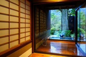 an entrance to a room with a window and a tree at Matsuzakaya Honten in Hakone