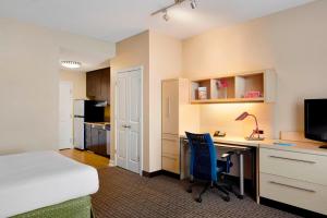 a bedroom with a bed and a desk with a computer at TownePlace Suites by Marriott Harrisburg Hershey in Harrisburg