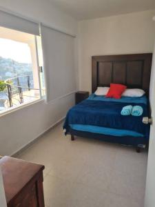 En eller flere senge i et værelse på Departamento en Grand Casa Blanca Acapulco
