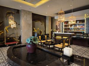 a lobby with a table and chairs and a piano at The Odys Boutique Hotel in Ho Chi Minh City