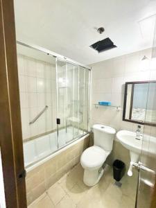 a bathroom with a toilet and a shower and a sink at Super OYO Capital O 907 Ceo Flats in Manila