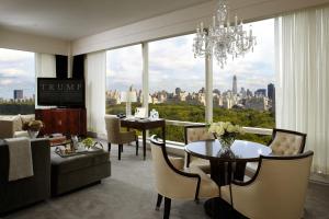 a living room with a chandelier and a table and chairs at Trump International New York in New York