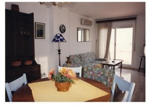 a living room with a table and a couch at Mar De Cunit in Cunit