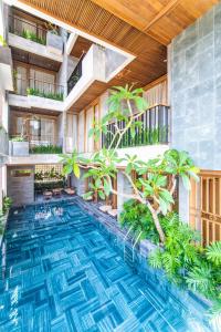 an indoor pool with plants in a building at Bonny Boutique Hotel Da Nang in Danang