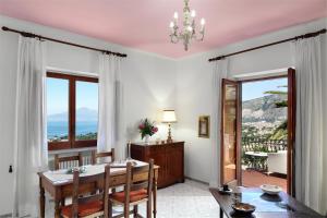 a dining room with a table and a view of the ocean at M Suites Sorrento in Sorrento