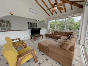 a living room with a couch and a fireplace at Villa Serena Playa Coronado in Chame