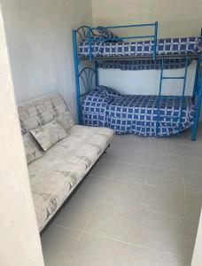 a room with two bunk beds and a couch at Loft 203 in Acapulco