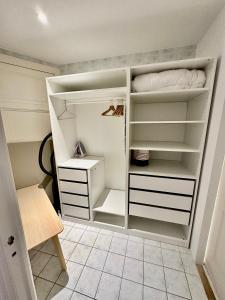 a walk in closet with white shelves at Luxurious Apartment with AC Promenade des Anglais up to 4 people B in Nice