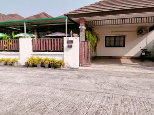 a house with a porch and a driveway at Wilderness in Ban Chang