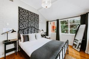 a bedroom with a bed and a large window at Mortimer Cottage - A Pool Oasis in Heart of Mudgee in Mudgee +37 photos