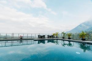 a swimming pool with a view of a mountain at The Panoramic Getaway in Munnar