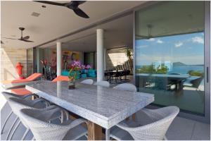 a dining room with a table and chairs on a patio at The Cube Ocean View Pool Villa Kalim in Patong Beach