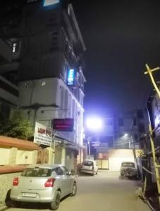 two cars parked on a street at night at Budget Hotel in Patna