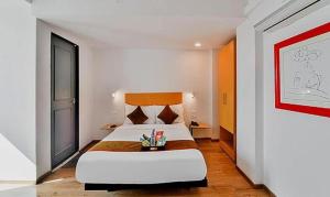 a bedroom with a large white bed in a room at FabHotel Lupin Internation in Udaipur