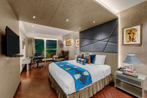 a large bedroom with a large bed and a desk at Marina- Shimla First Designer Boutique Hotel in Shimla