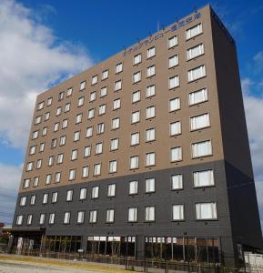 a large brown building with many windows at Hotel Grand View Fukuoka-Kuko in Hakata