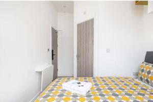 a bedroom with a bed with a towel on it at Victorian Functional Accommodation 5Min Walk From Tufnell Park in London