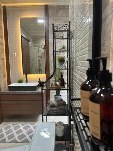 a bathroom with a tub and a sink and a mirror at Deluxe Residence Kalibata 8 in Jakarta