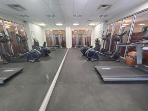 a gym with rows of treadmills and machines at Beautiful one bedroom oceanfront condo in Daytona Beach