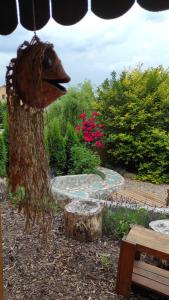 a wooden bird statue sitting next to a bench at Apartments Sharka in Děčín