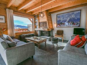 a living room with two couches and a fireplace at Chalet Le Grand-Bornand, 6 pièces, 12 personnes - FR-1-391-116 in Le Grand-Bornand