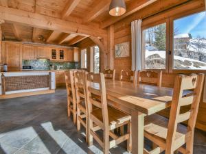 a kitchen and dining room with a wooden table and chairs at Chalet Le Grand-Bornand, 6 pièces, 12 personnes - FR-1-391-116 in Le Grand-Bornand