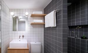 a bathroom with a sink and a toilet and a mirror at base-SUHE Serviced Apartment in Shanghai