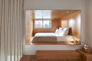 a bedroom with a bed in a large mirror at base-SUHE Serviced Apartment in Shanghai