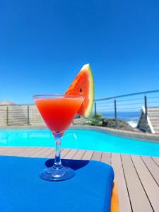 a drink in a glass with a slice of watermelon at Brenton Haven Beachfront Resort in Knysna