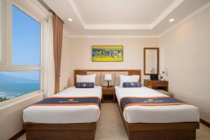 Postelja oz. postelje v sobi nastanitve BlueSun Danang Beach Hotel