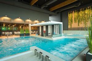 a large swimming pool in a building with a large swimming pool at Hotel Jurmala Spa in Jūrmala