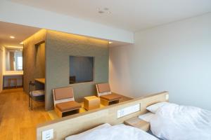 Ένα ή περισσότερα κρεβάτια σε δωμάτιο στο Kameya Hotel