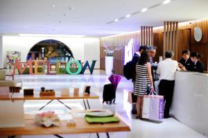 a group of people standing in a store at Mellow Fields Hotel in Taipei