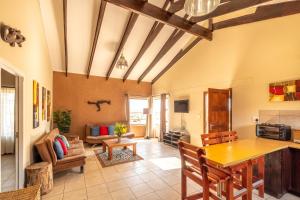 a living room with a wooden table and a couch at Gecko Ridge in Swakopmund