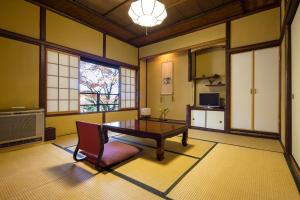 a large room with a table and a chair in it at Matsuzakaya Honten in Hakone