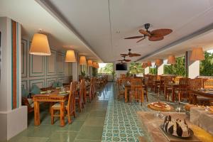 a restaurant with wooden tables and wooden chairs at Southern Star,Bangalore in Bangalore