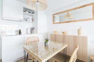 a kitchen with a table and chairs in a room at Sugar Beach Boutique Studio in Platja d'Aro