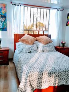 a bedroom with a bed with a large window at Apartaestudio tipo LOFT INDEPENDIENTE in Bogotá