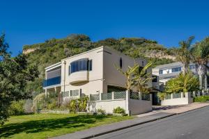 a house on the side of a hill at Maison Blue - Chic Garden Apartment in Napier