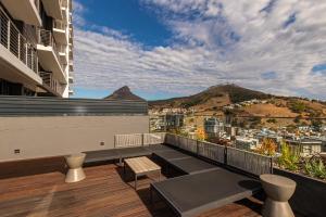 a balcony with a view of the city and mountains at Beautiful Family Apartment with amazing views @ 16 on Bree in Cape Town