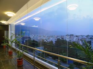 a balcony with a view of a city at Renest Tirupati in Tirupati